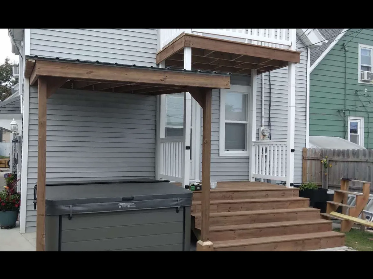 Covered wood back porch with stained stairs
